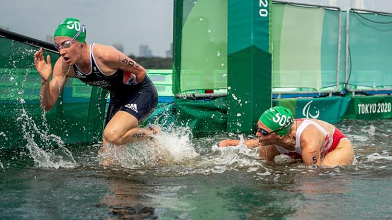 Two female Para triathletes are exiting the water